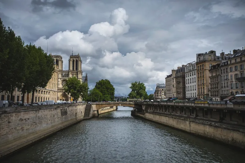 A river running through a city next to tall buildings